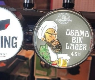 A close-up of a beer tap handle featuring a cartoon illustration of a man with a white turban and beard, holding a beer mug…