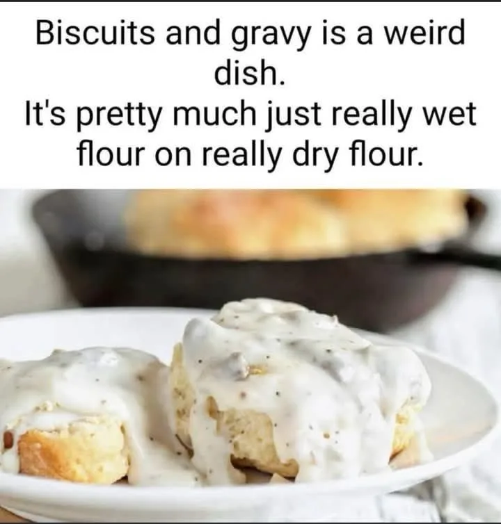 A close-up photo shows two golden-brown biscuits on a white plate, generously covered in creamy white gravy speckled with…
