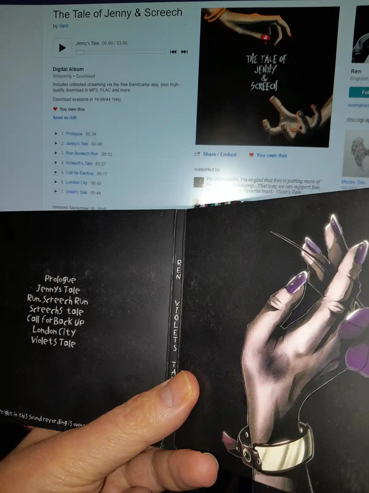 A person holds a physical album booklet for 'The Tale of Jenny & Screech' by Ren, showing the tracklist on the left page and…