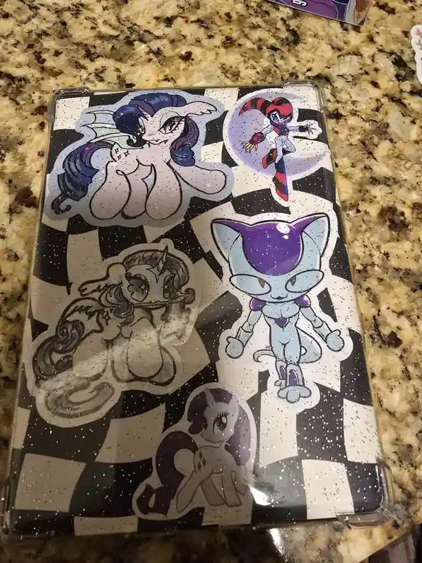 A clear phone case with a black-and-white checkerboard pattern and glitter is decorated with five anime-style stickers…