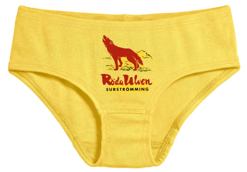 A yellow pair of men's underwear features a red silhouette of a howling wolf against a stylized sunset or mountain backdrop…