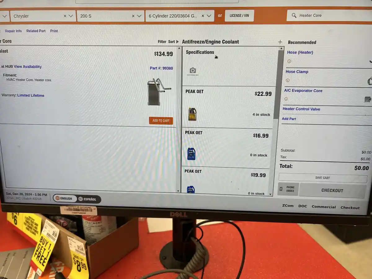 A computer screen displays an auto parts website showing a $134.99 heater core with a 'PEAK OET' coolant listed at $22.99…