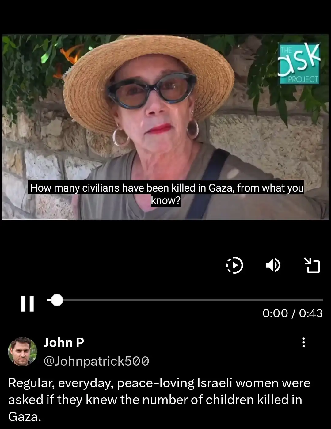 A still image from a video shows an older Israeli woman wearing a straw hat and large glasses, looking directly at the…