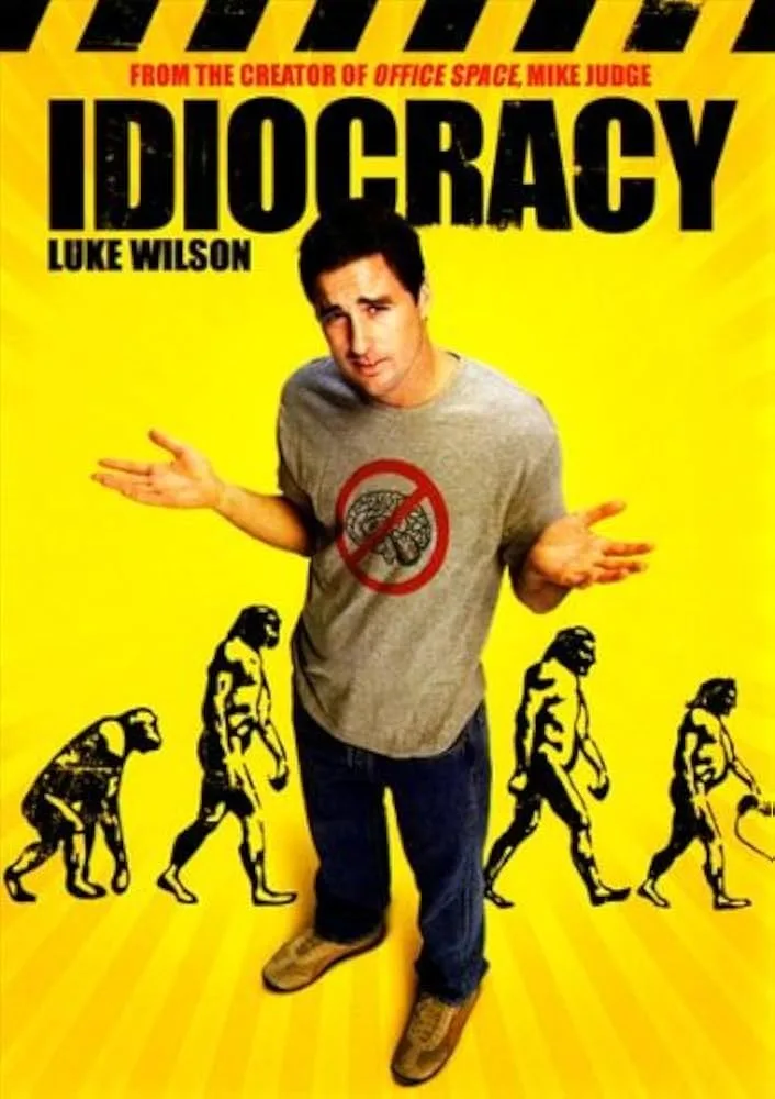 A movie poster for 'Idiocracy' featuring actor Luke Wilson in a gray t-shirt with a red circle and slash over a brain…