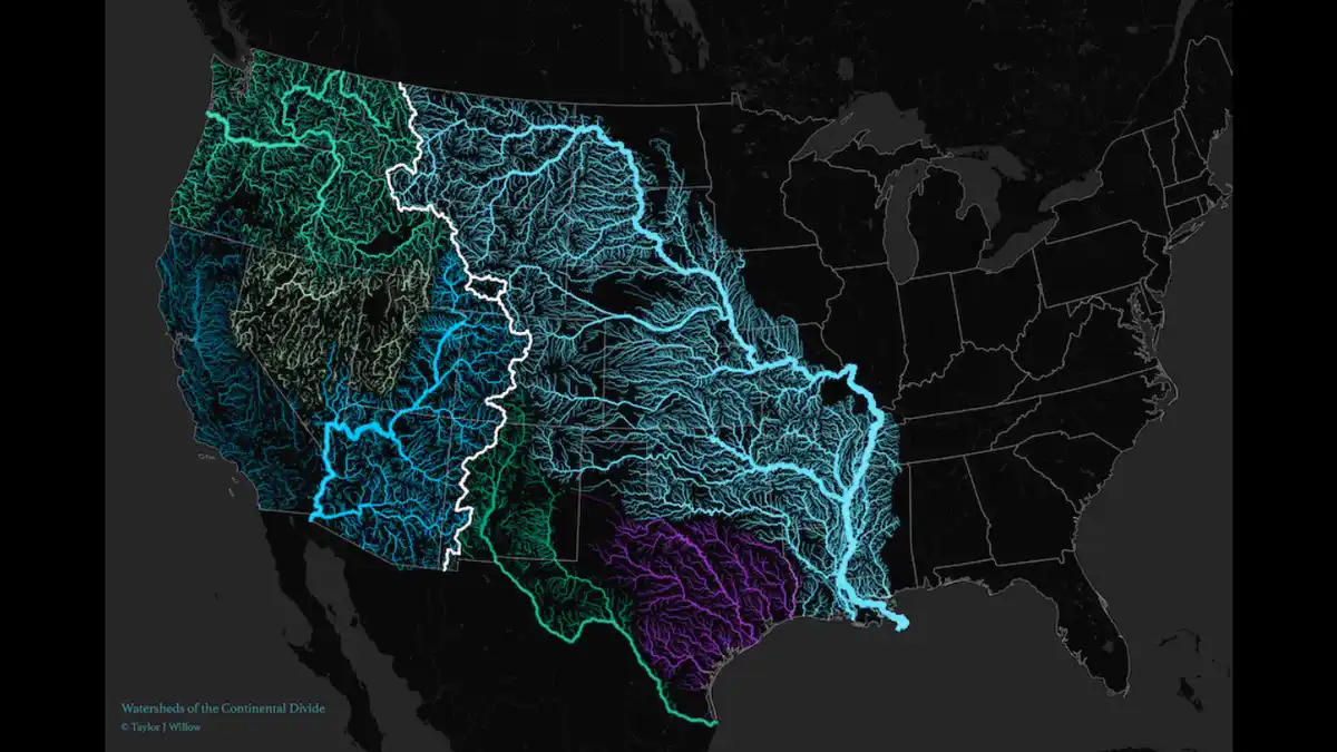 A dark map of the United States shows glowing, color-coded river networks flowing from the Continental Divide, with teal…