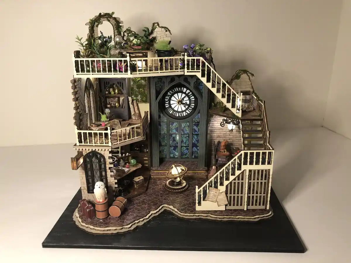 A highly detailed miniature model of a multi-level house with gothic architecture, stained glass windows, and a large clock…