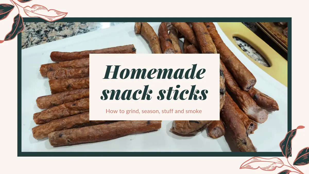 A white plate holds numerous brown, cylindrical snack sticks with charred spots, resembling homemade sausages or smoked meat…