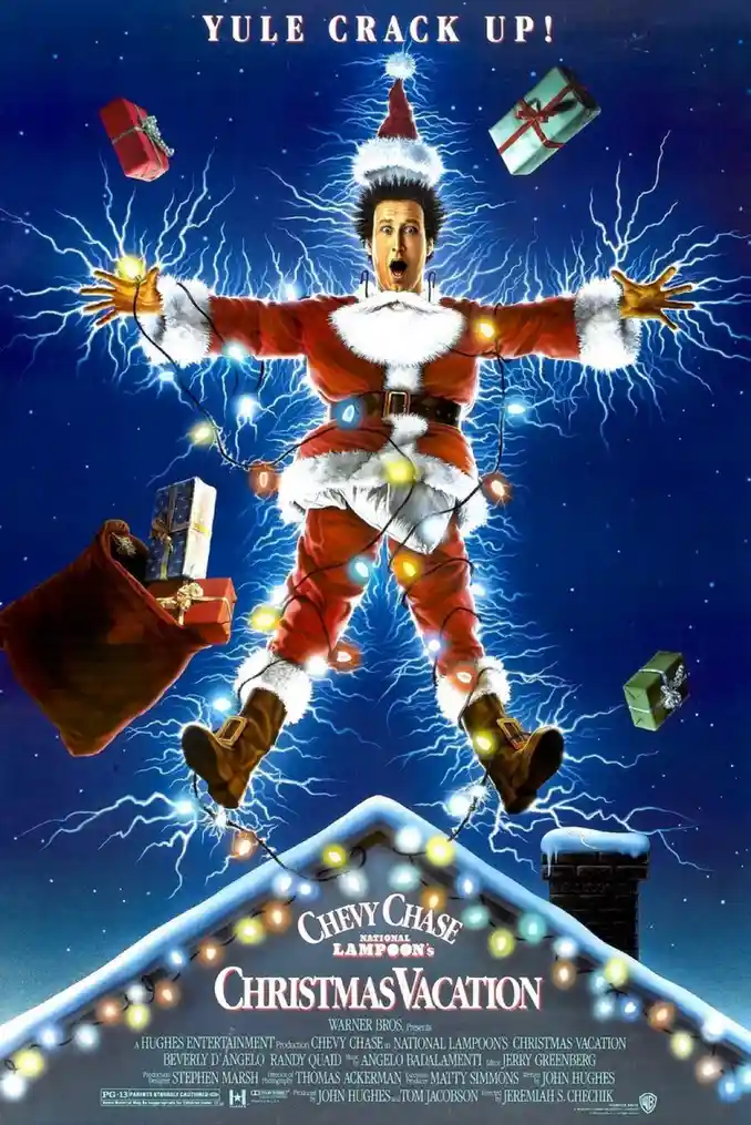 A movie poster for 'National Lampoon's Christmas Vacation' shows actor Chevy Chase as a man in a Santa suit, suspended in…