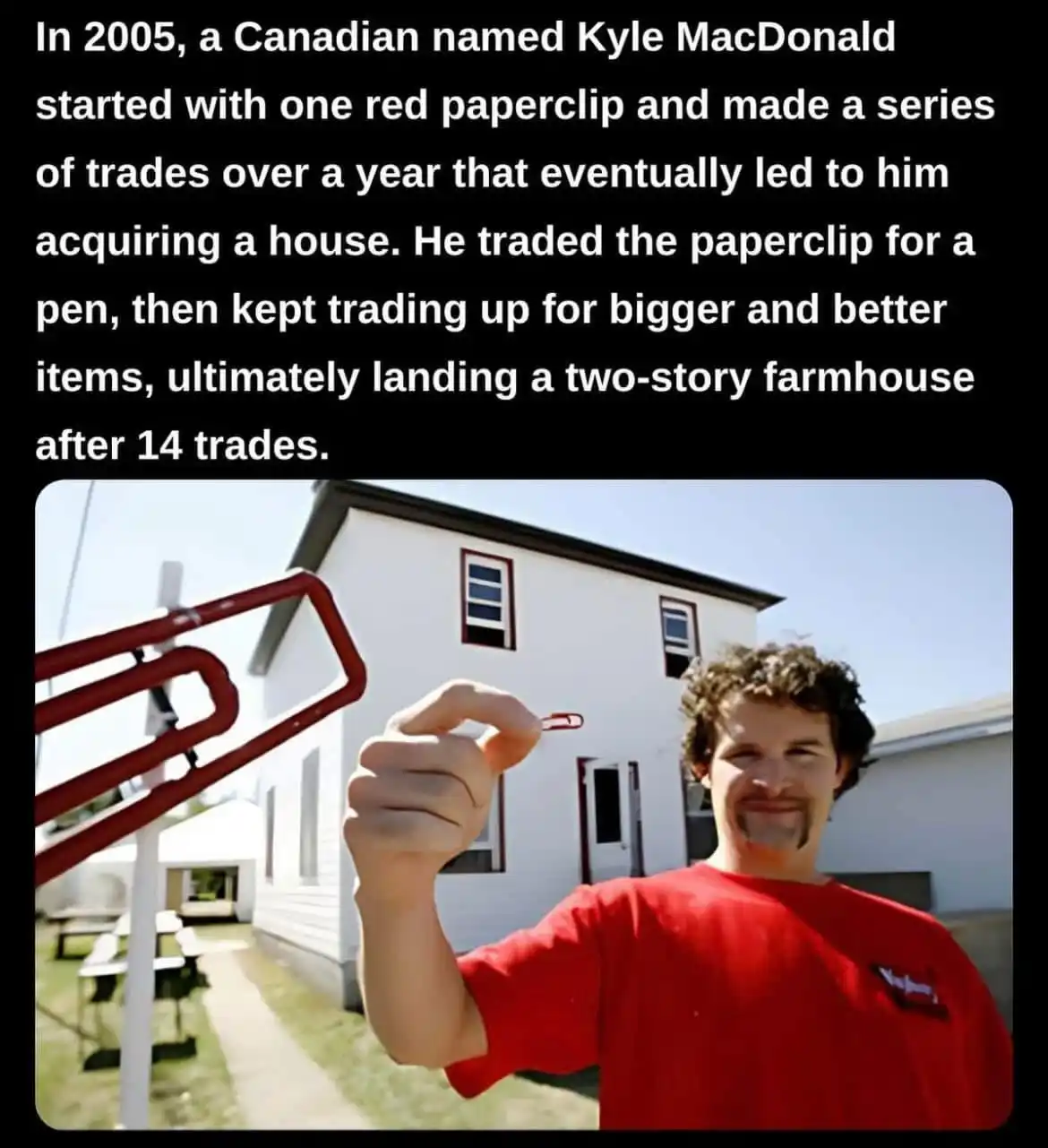 A man in a red shirt holds up a small red paperclip in front of a two-story white farmhouse. The image is overlaid with text…