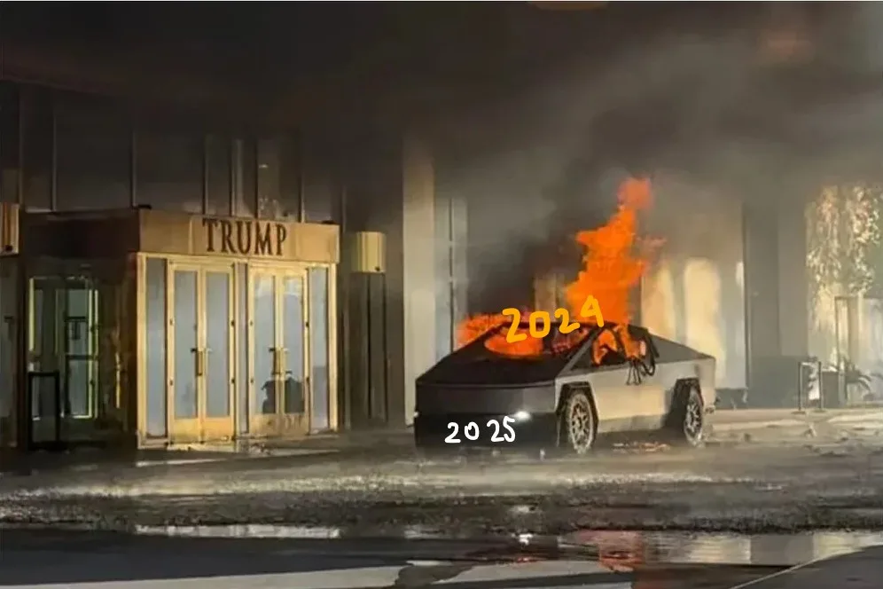 A black Tesla Cybertruck is engulfed in flames in front of a building with a golden 'TRUMP' sign above its entrance. The…