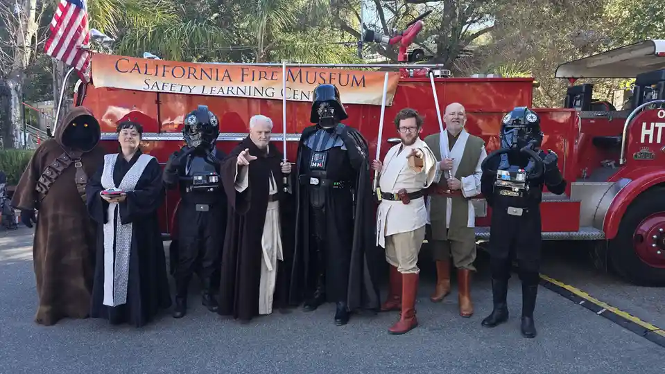A group of people dressed as Star Wars characters, including Darth Vader, Obi-Wan Kenobi, Luke Skywalker, Yoda, and…