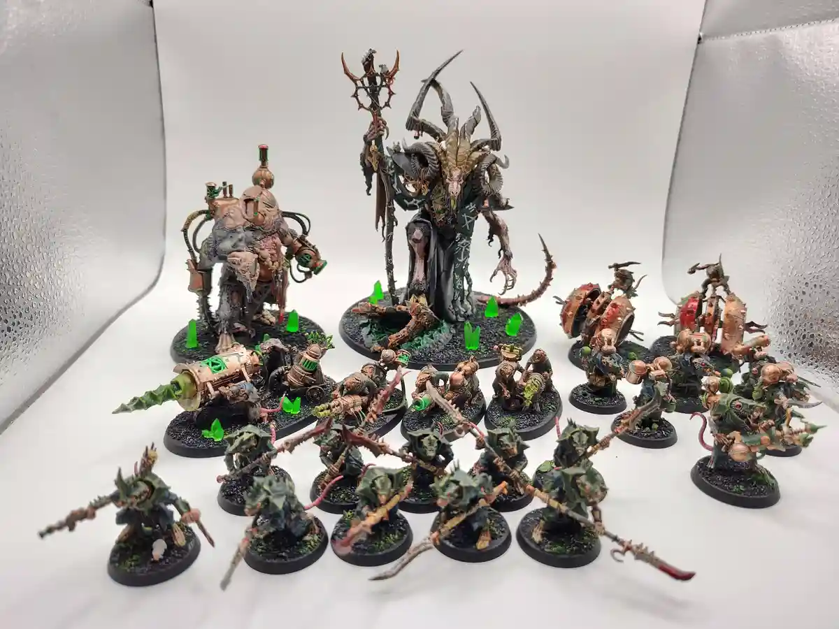 A collection of intricately painted miniature figurines, including a large horned demon-like figure holding a staff, a…