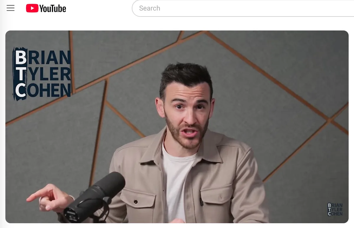 A screenshot of a YouTube video thumbnail featuring Brian Tyler Cohen, a man with a beard wearing a beige jacket over a…