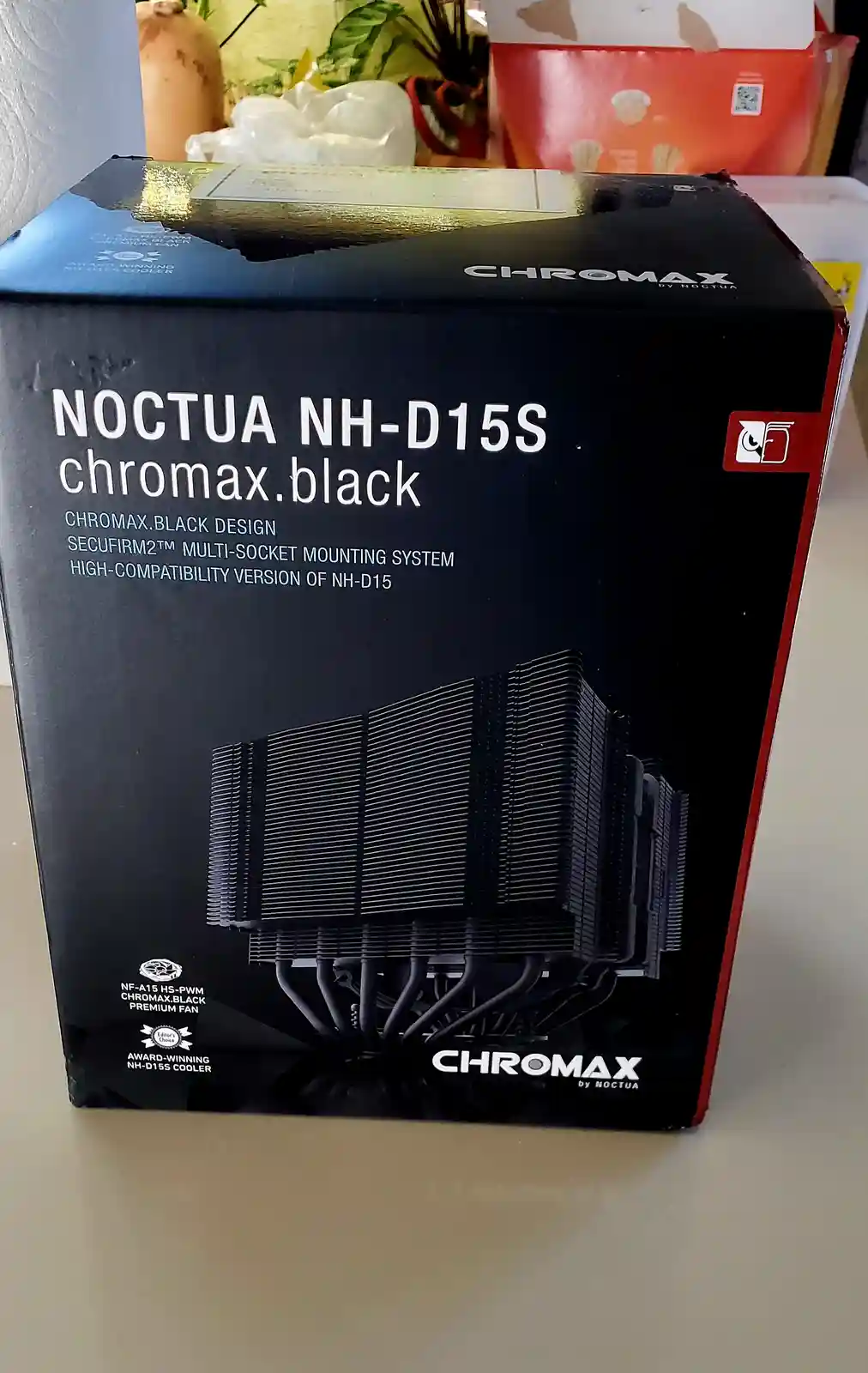 A black product box for a Noctua NH-D15S chromax.black CPU cooler is shown, featuring an image of the heatsink and text…