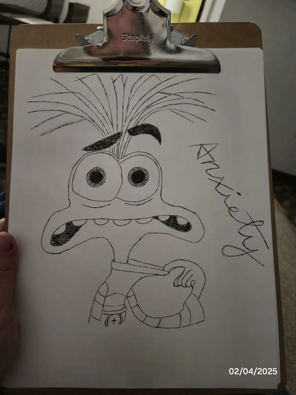 A hand-drawn black-and-white sketch on a white sheet of paper, held by a brown clipboard with a silver Staples clip. The…