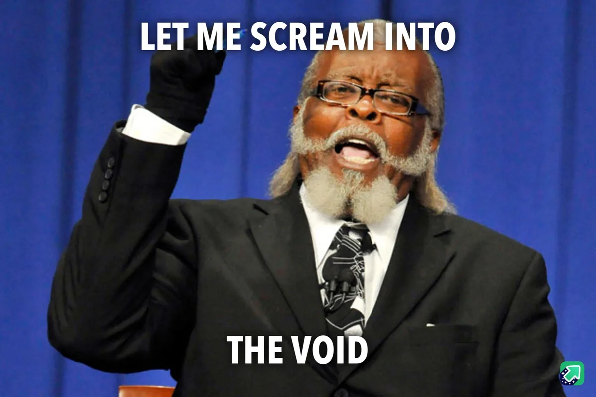 A man in a black suit and glasses, with a white beard and black gloves, is captured mid-scream with his right fist raised…