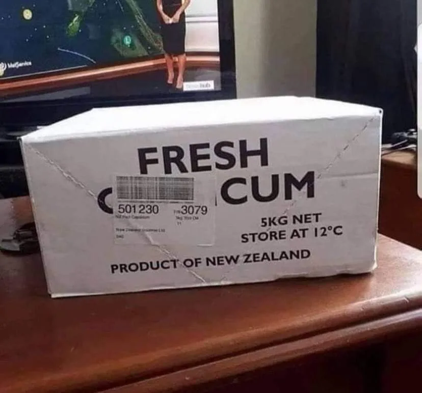 A white cardboard box sits on a wooden surface, labeled with large black text that reads 'FRESH CUM', followed by '5KG NET'…