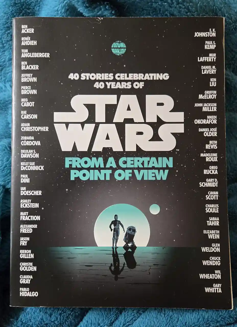 The image shows the cover of the 'Star Wars: From a Certain Point of View' anthology book, featuring the iconic Star Wars…