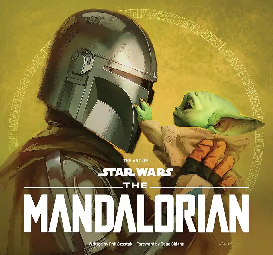 The image shows a close-up of the Mandalorian in his iconic helmet, holding the child Grogu (Baby Yoda) in his arms. Grogu…