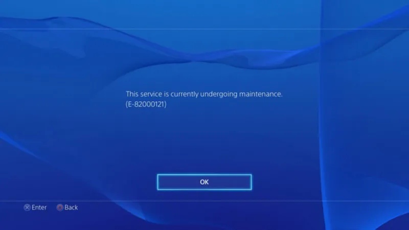 A blue PlayStation error screen displays the message 'This service is currently undergoing maintenance. (E-82000121)' with…
