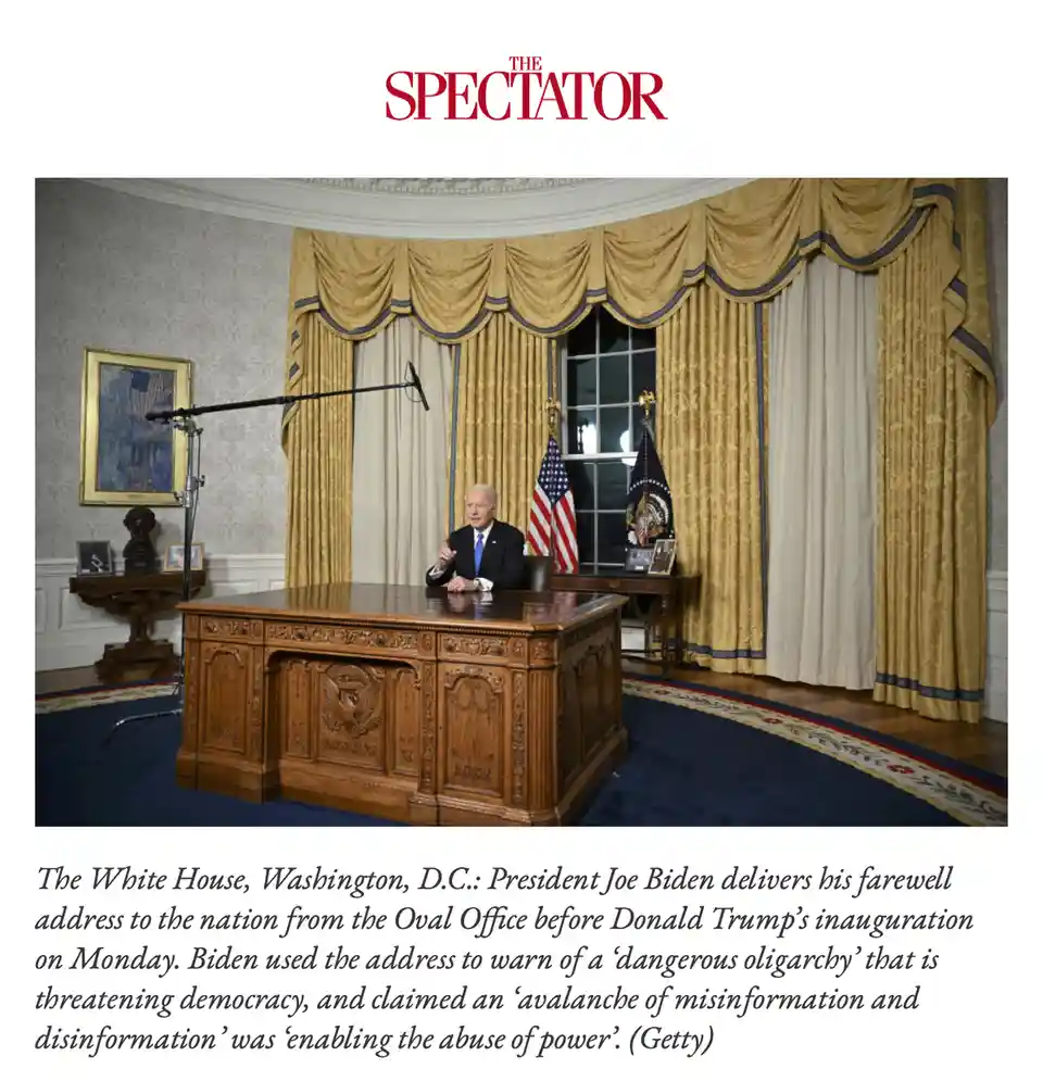 A photo of President Joe Biden seated at the ornate Oval Office desk, speaking into a microphone, with American flags and…