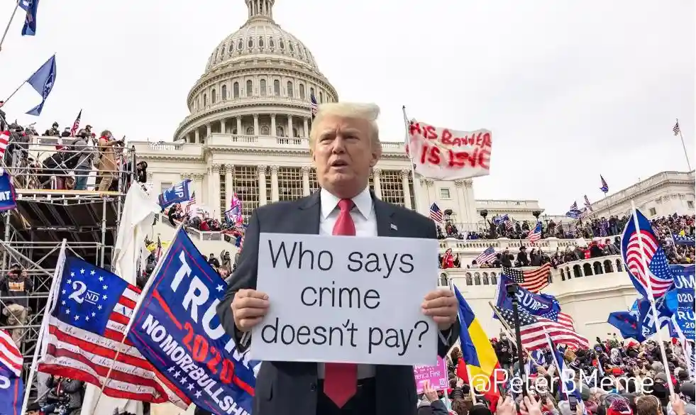 A man in a suit and red tie stands in front of the U.S. Capitol building holding a white sign that reads 'Who says crime…