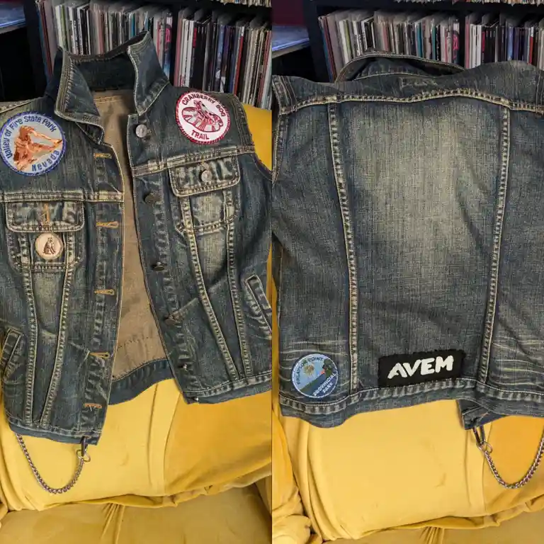 A denim vest is shown from front and back, displaying various embroidered patches on the front like 'Valley of Fire State…