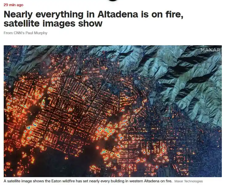 A satellite image from Maxar Technologies shows a town with numerous bright orange and red hotspots scattered across its…