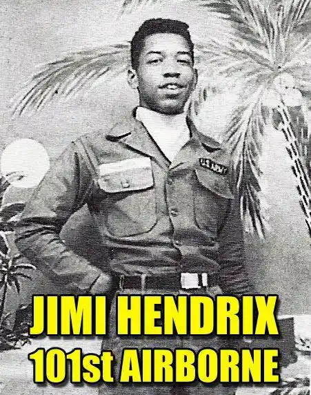 A black-and-white vintage photo of a young Black man in a U.S. Navy uniform, standing with one hand on his hip against a…