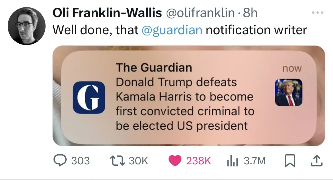 A screenshot of a tweet by Oli Franklin-Wallis praising a 'Guardian notification writer' for a fake news alert. The alert…