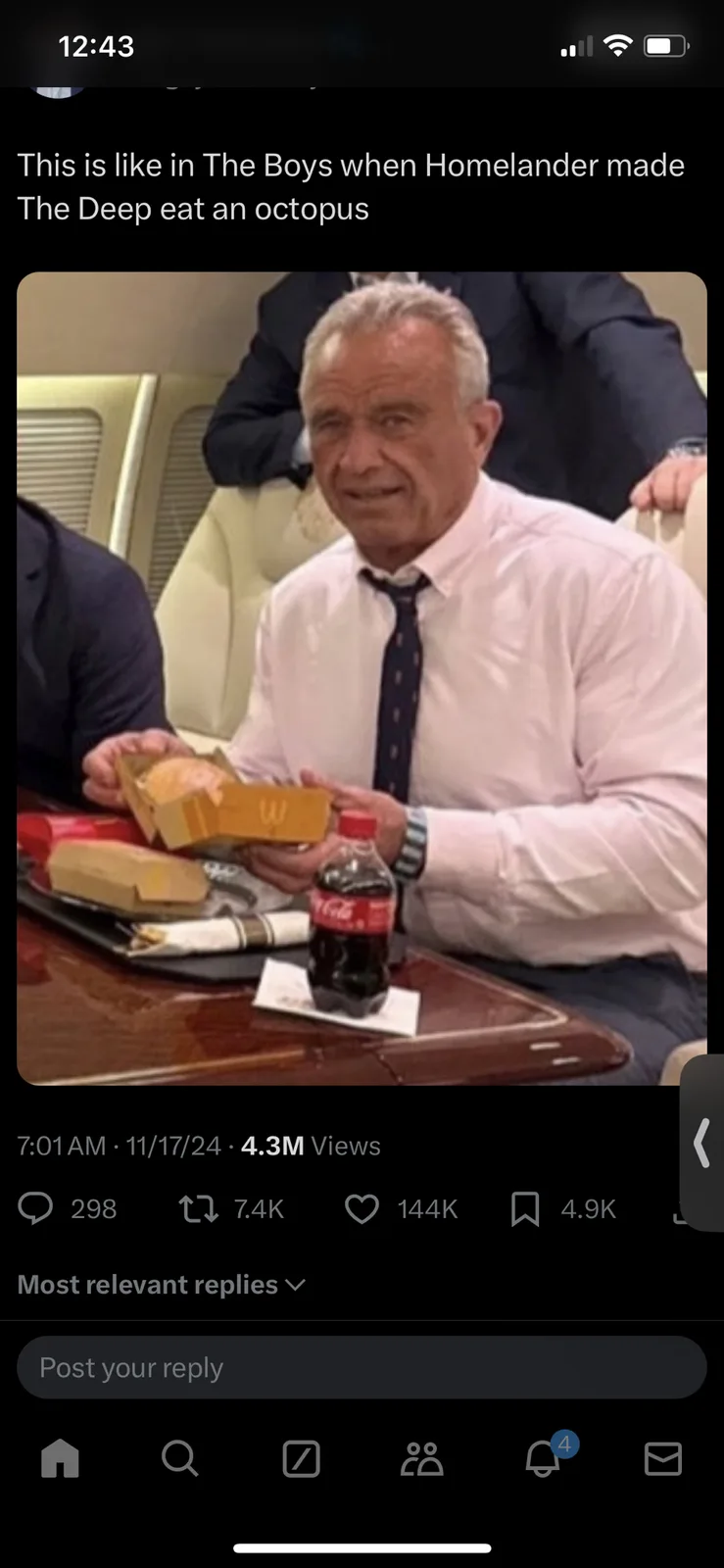 An older man in a white shirt and tie sits at a table in what appears to be a private jet, holding a McDonald's burger box…