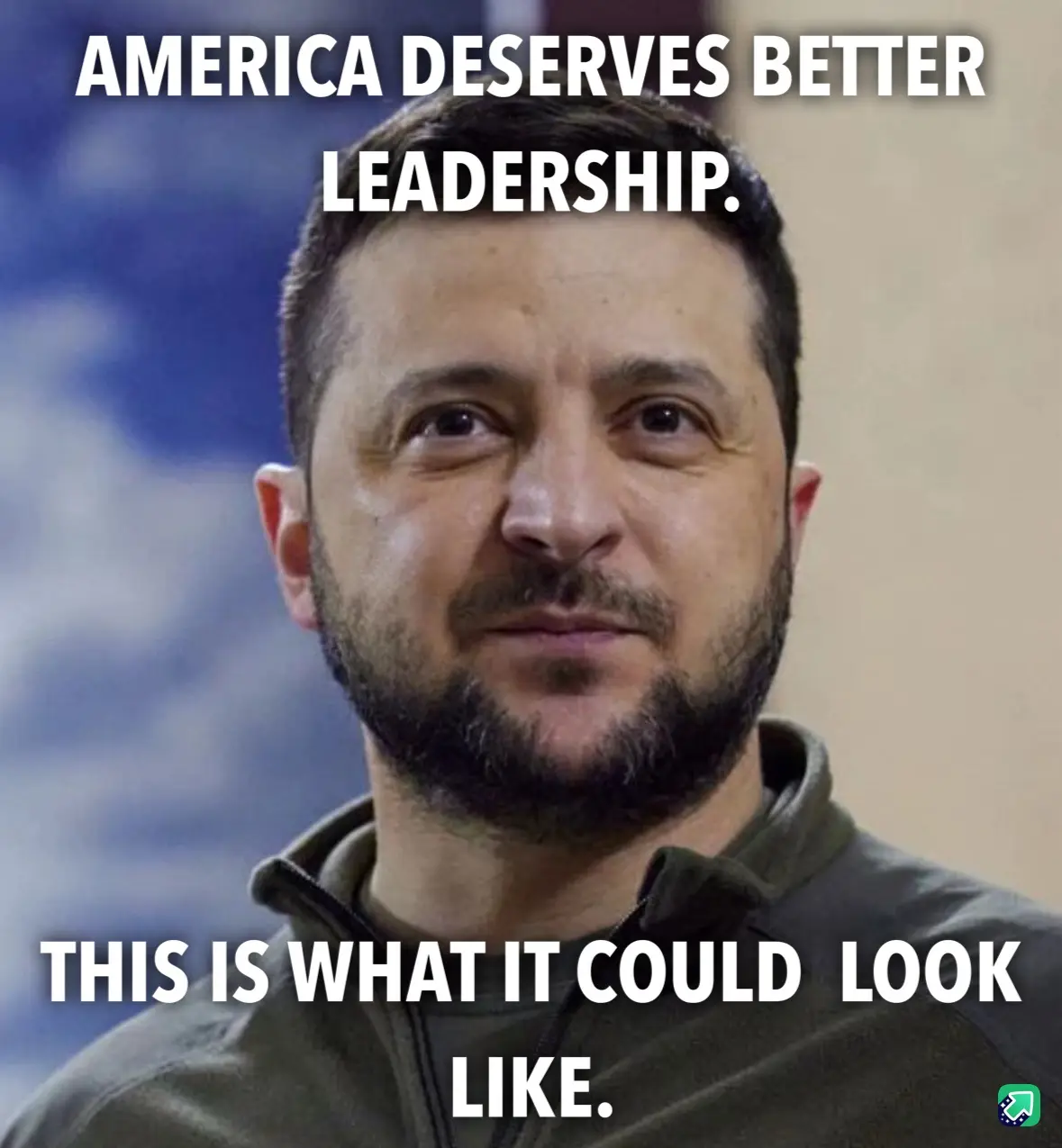A close-up image of a man with a beard and short hair wearing a dark green zip-up jacket, looking directly at the camera…