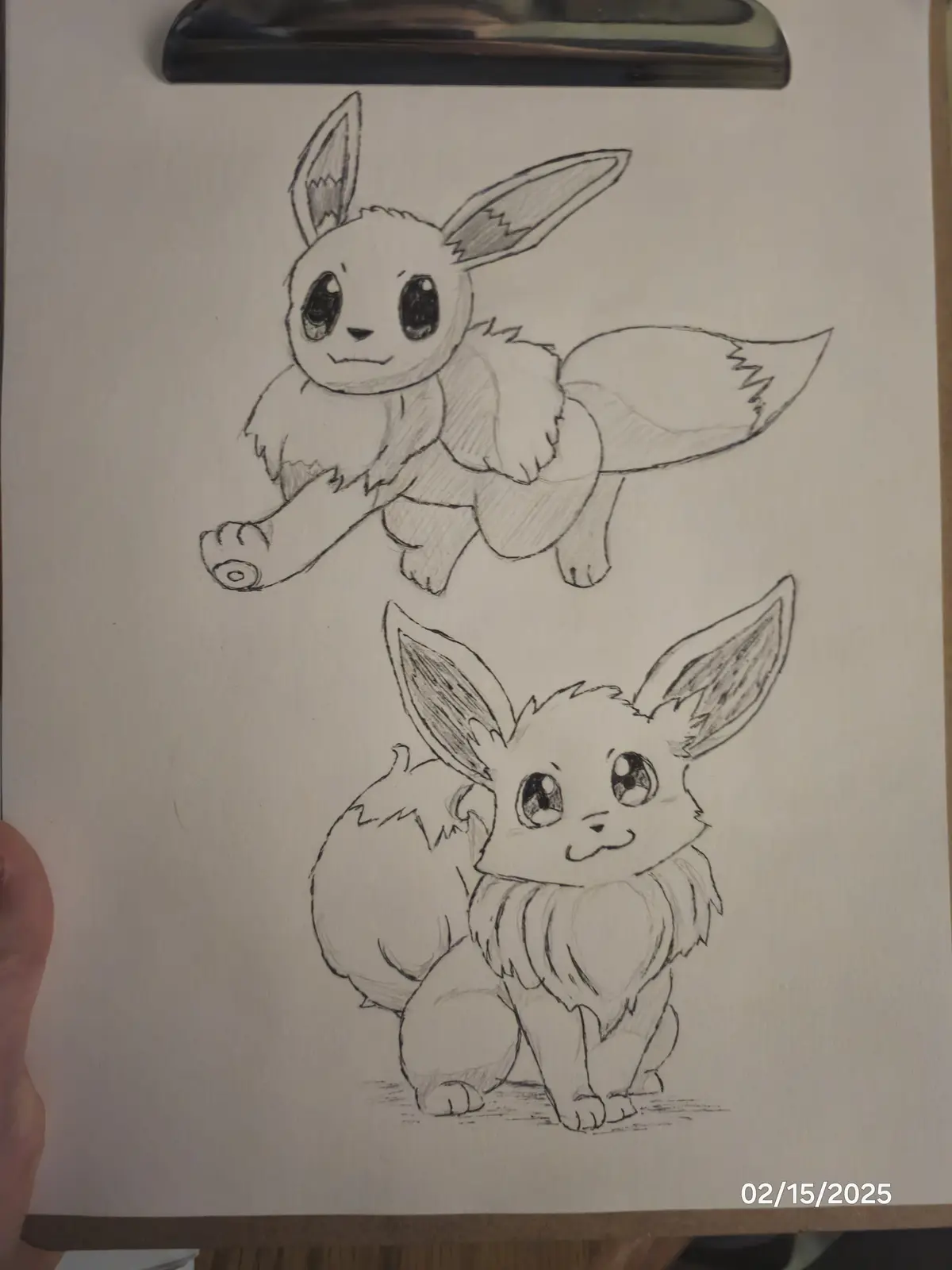 A pencil sketch on paper shows two drawings of the Pokémon Eevee, one above the other. The top Eevee is drawn in a running…