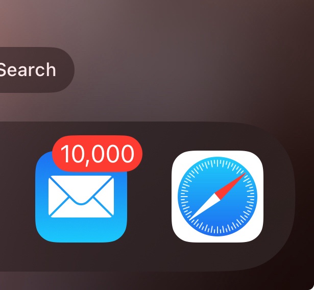 An iPhone home screen shows the Mail app icon with a red notification badge displaying '10,000', positioned next to the…