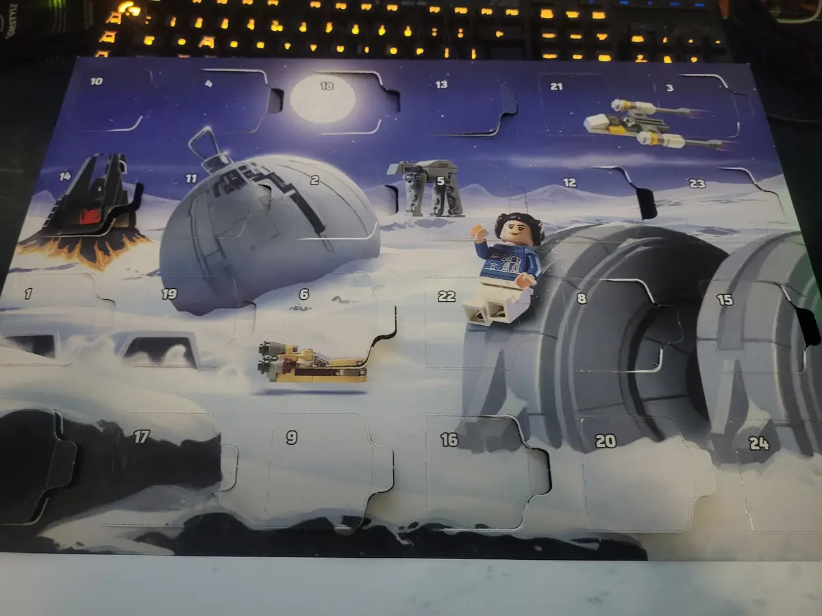 A Lego Star Wars Advent Calendar is shown with many numbered compartments open, revealing a Lego figure of Leia Organa…