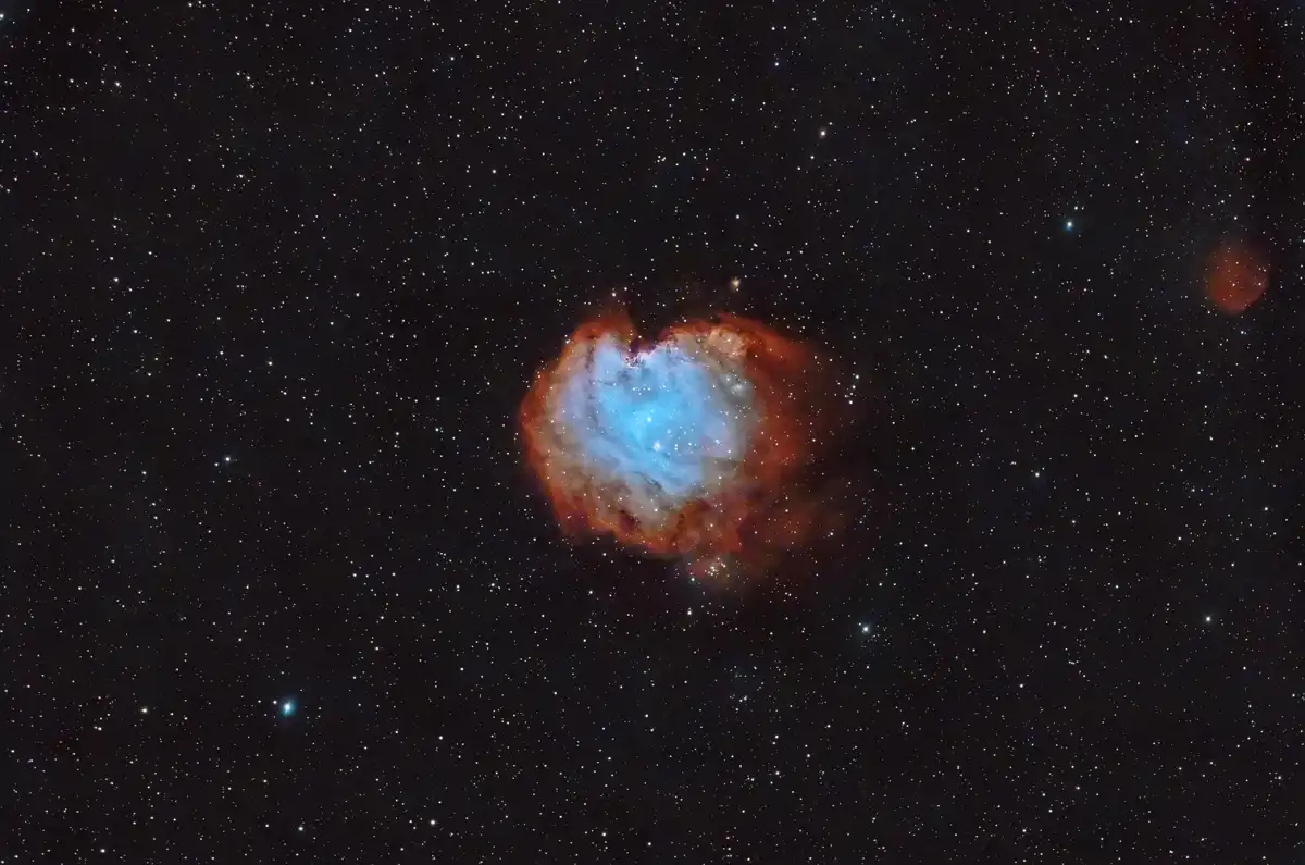 A deep-sky astrophotograph shows a glowing nebula with a distinct heart-like shape against a starfield, overlaid with the…