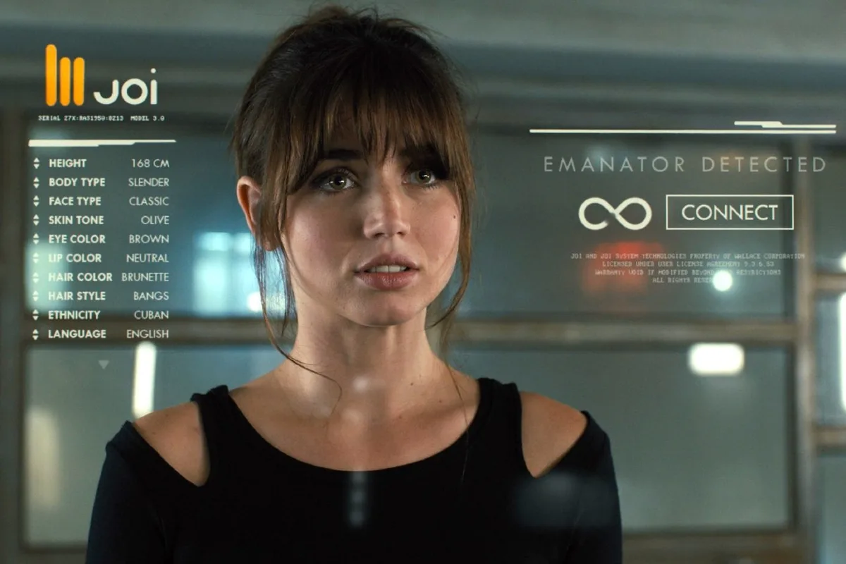 A woman with brown hair and a black top stares forward as a futuristic interface overlays her left side, displaying her…