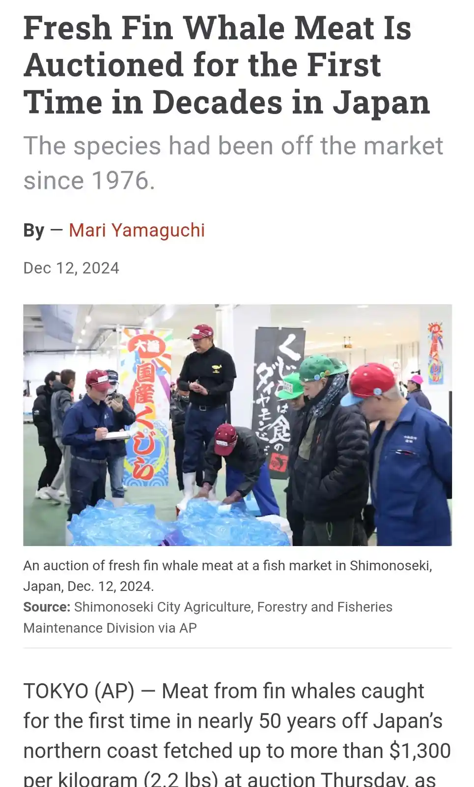 A news article screenshot shows a group of men in work clothes and caps gathered around large blue-wrapped packages, likely…