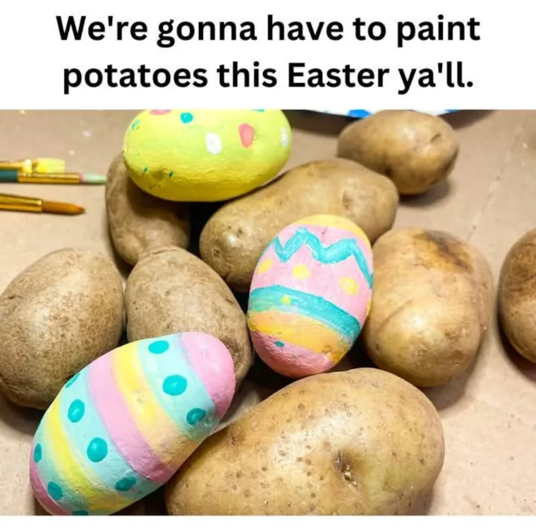 A close-up photo shows several brown potatoes scattered on a surface, with three of them painted to resemble colorful Easter…