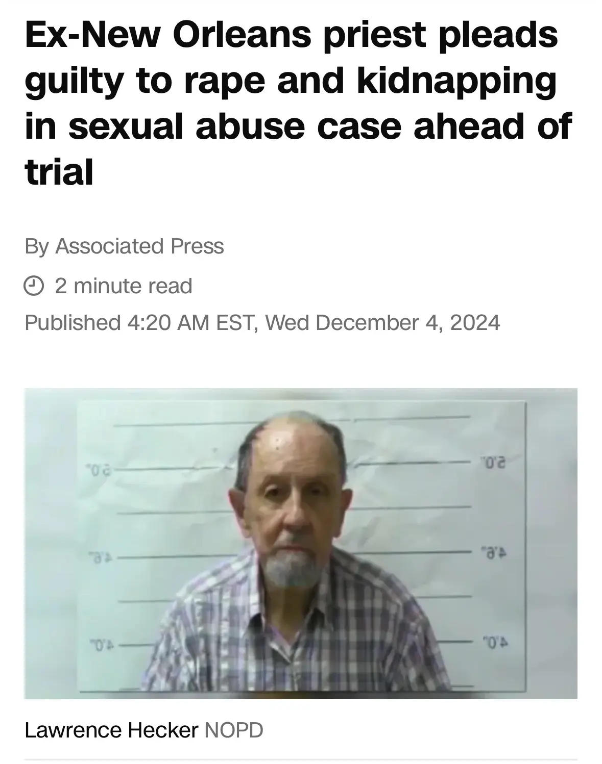 A mugshot of an older man with a gray beard and plaid shirt, standing before a height chart. The image is overlaid with a…