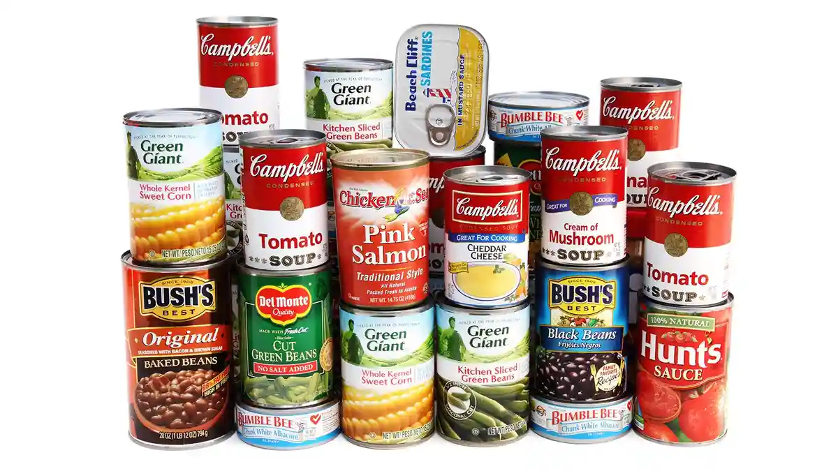 A large collection of canned goods including Campbell's soup, Green Giant vegetables, Bush's baked beans, Bumble Bee tuna…