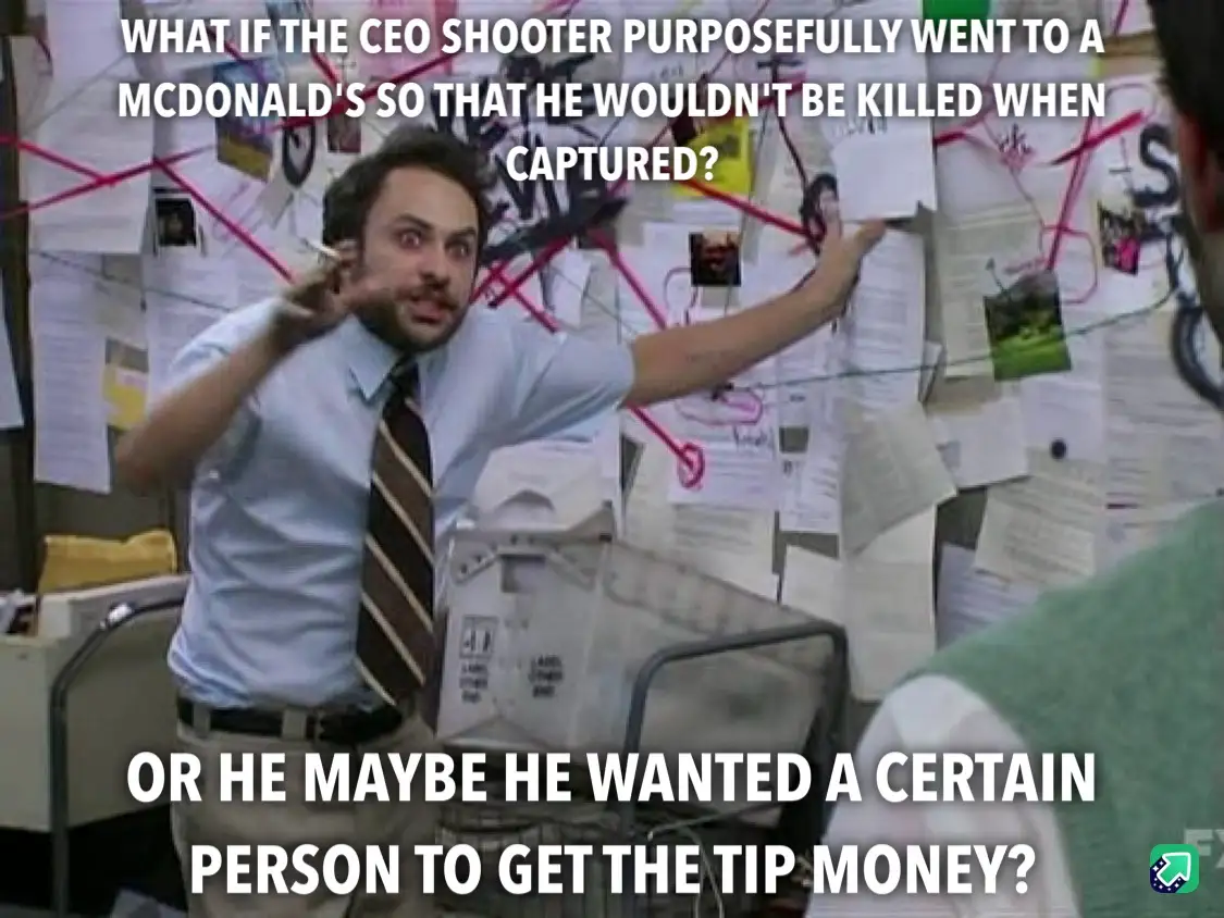 A man in a light blue shirt and striped tie stands in front of a cluttered bulletin board covered in photos and notes…