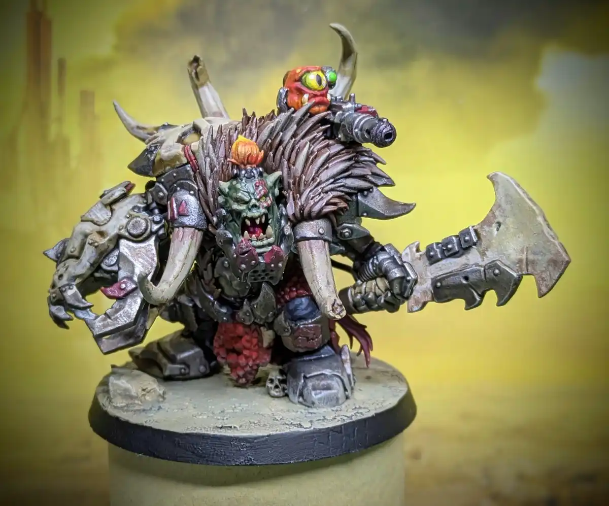 A heavily detailed, painted miniature of a monstrous, horned warrior with multiple heads, one green and one red, wearing…