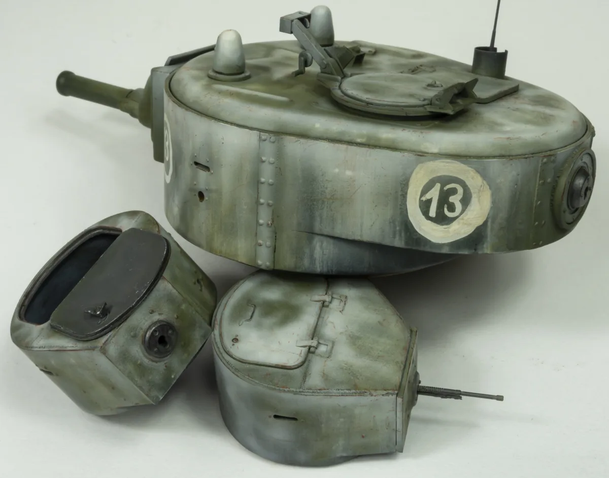A model of a German World War II tank, specifically a Panzerkampfwagen II, is shown disassembled into its main turret, hull…