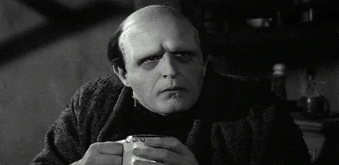A black-and-white image sequence shows a bald man in a dark robe holding two mugs, then drinking from one, then holding a…