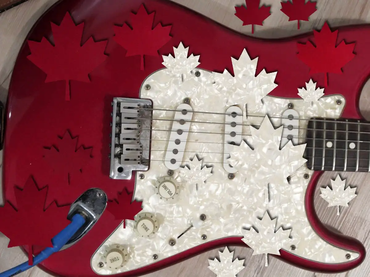 A red electric guitar is covered with red and white maple leaf cutouts, some overlapping the pickguard and knobs. The…