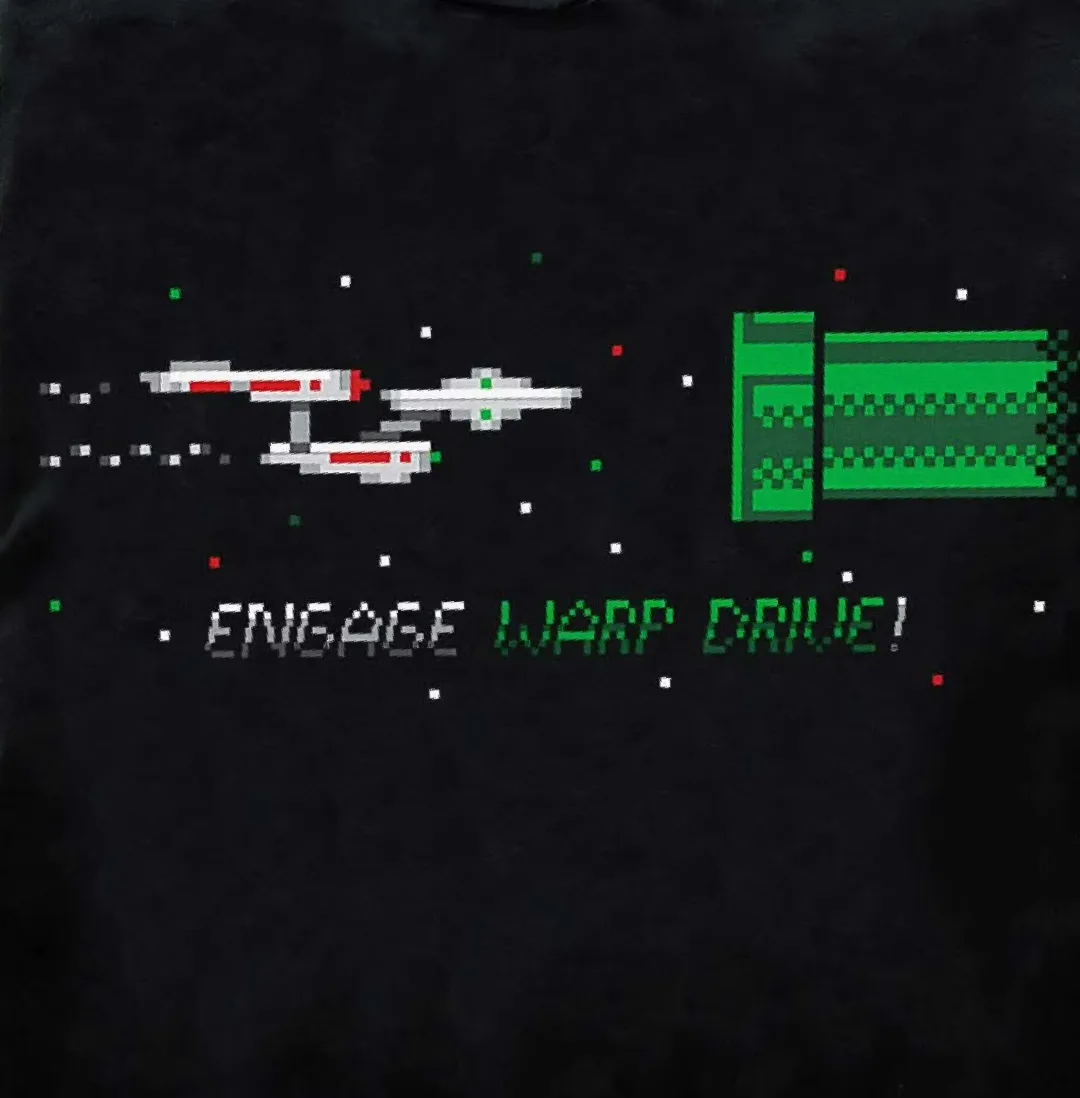 A black t-shirt features a pixelated, retro video game style graphic of a Star Trek spaceship and a green warp drive panel…