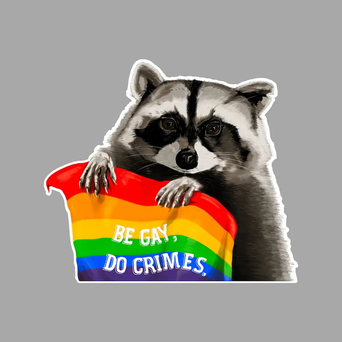 A cartoon raccoon with a black mask and gray fur is holding a rainbow flag, which has the text 'BE GAY, DO CRIMES.' written…