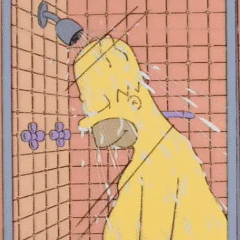 The image shows Homer Simpson in a shower, water streaming from the showerhead over his head. He has his eyes closed and…