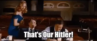 A sequence of six frames from a movie scene showing a man in a vest and tie progressively becoming more ecstatic and…